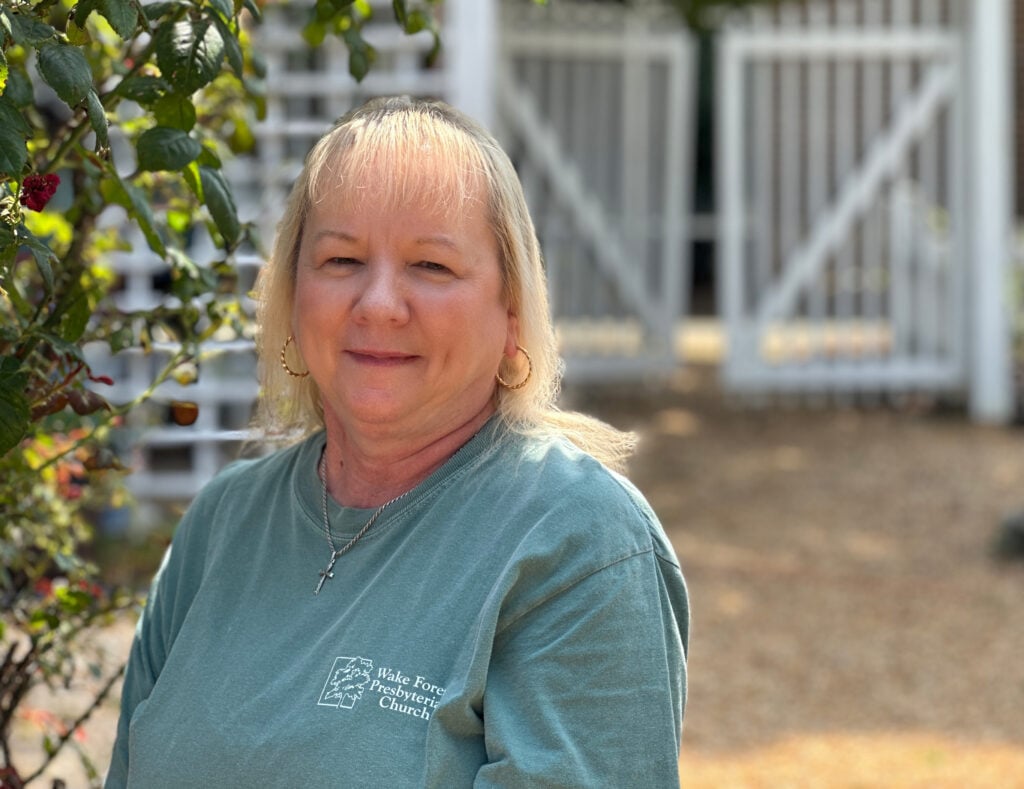 Photo of a smiling woman wearing a WFPC T-shirt