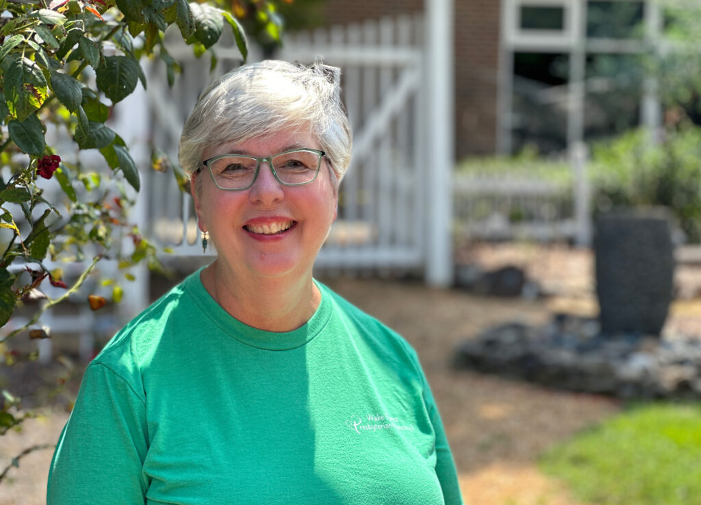 Photo of a mature, smiling woman wearing a WFPC Preschool T-shirt