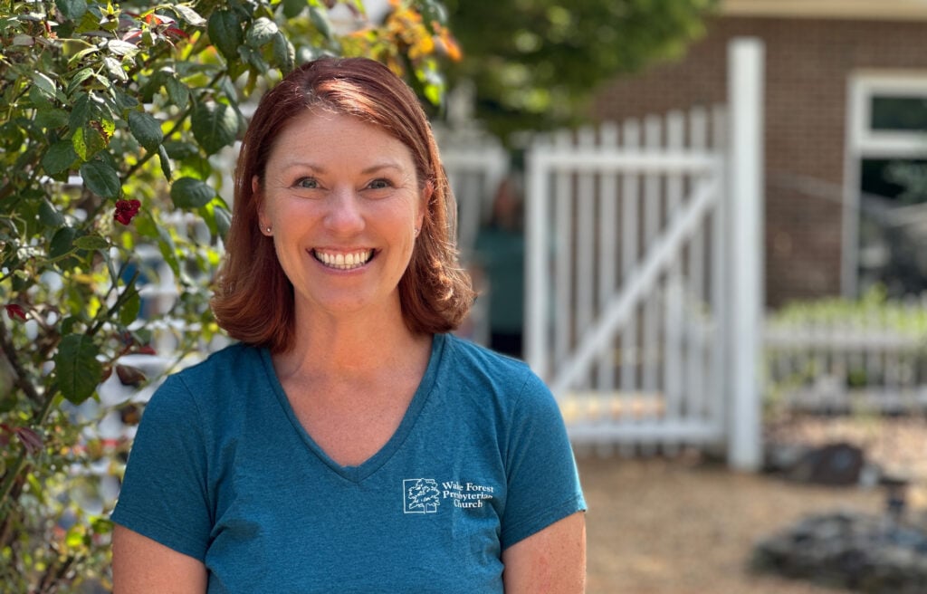 Photo of a smiling Gen X woman wearing a WFPC T-shirt
