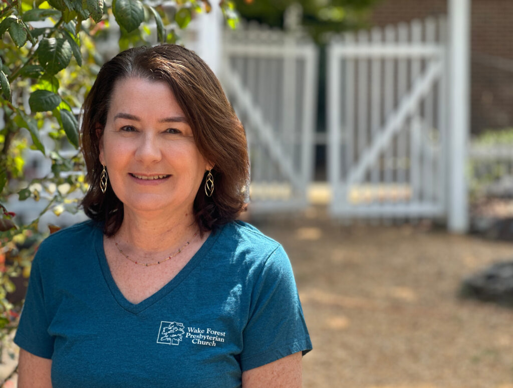 Photo of a smiling woman wearing a WFPC T-shirt