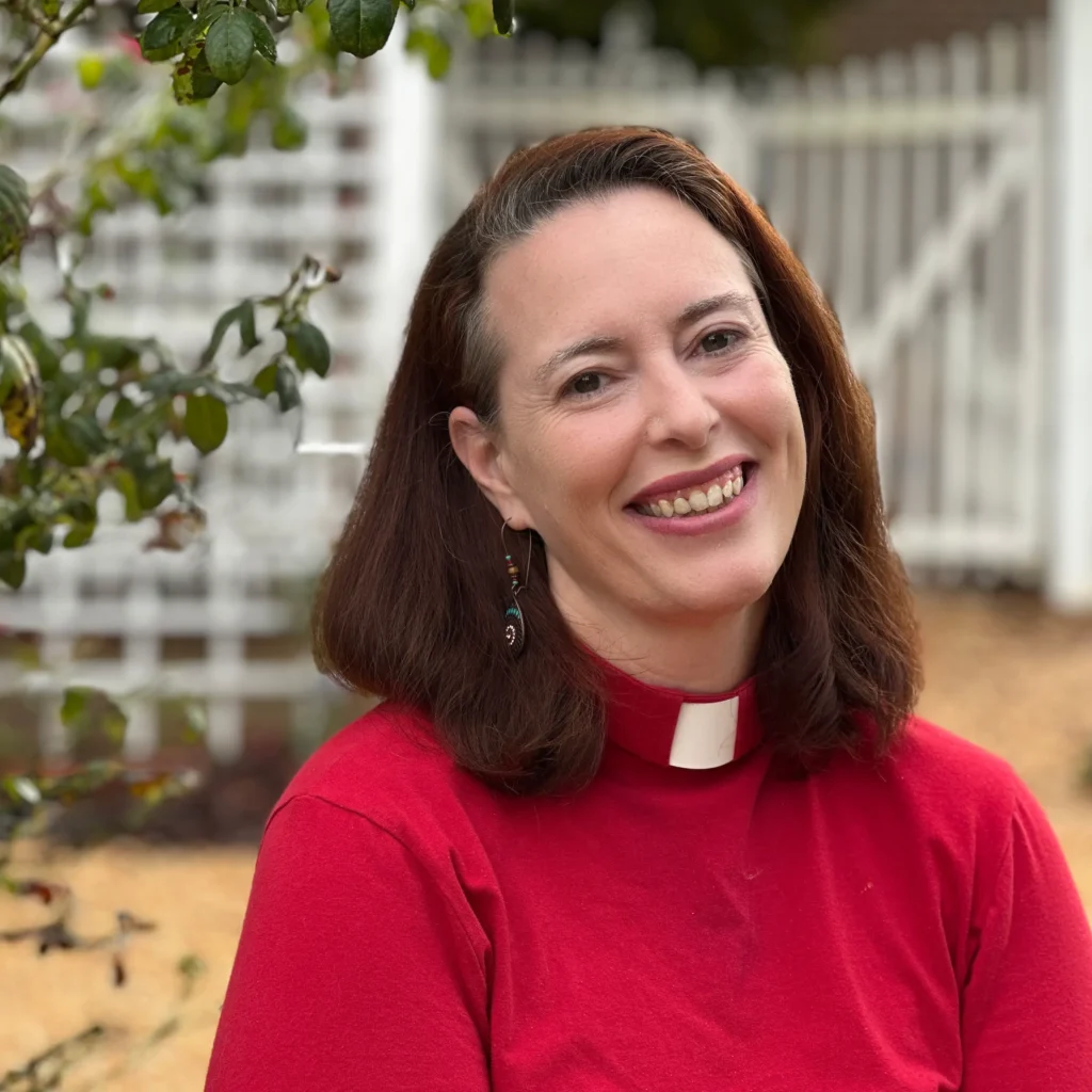 Photo of smiling millennial woman wearing a clerical collar